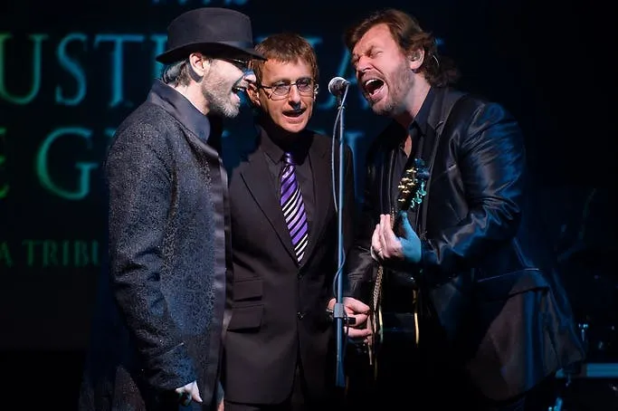 The Australian Bee Gees Show tribute trio singing together at the microphone on stage