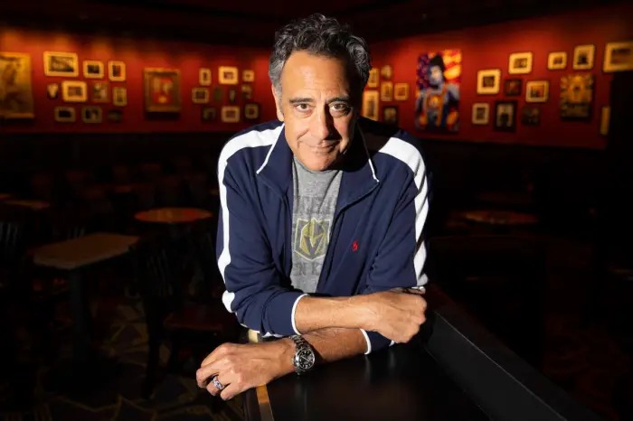 Stand-up comedian performing on stage at Brad Garrett's Comedy Club