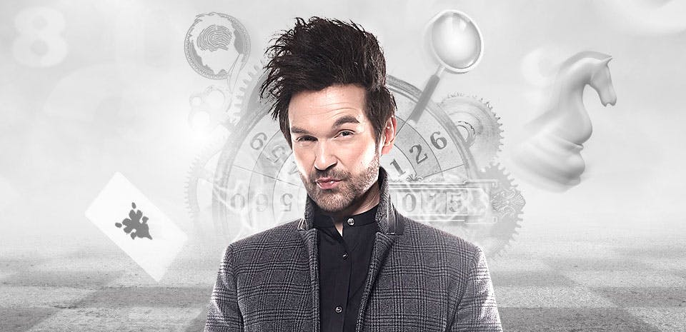 Colin Cloud in a grey plaid sport coat standing against a misty grey background surrounded by floating detective symbols — a clock face with gears, a magnifying glass, a chess knight, a playing card, and a brain — promotional image for Colin Cloud Mastermind at Harrah's Las Vegas