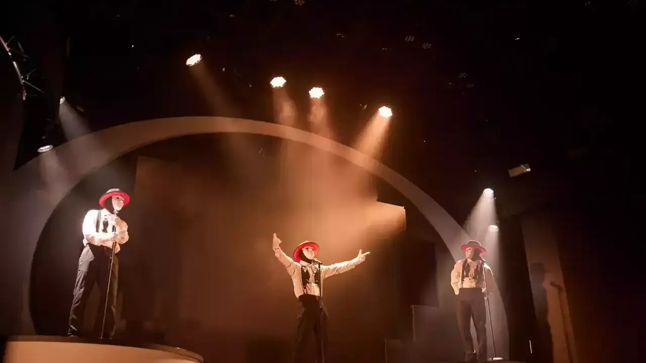 Jabbawockeez performers under dramatic warm stage lighting at MGM Grand