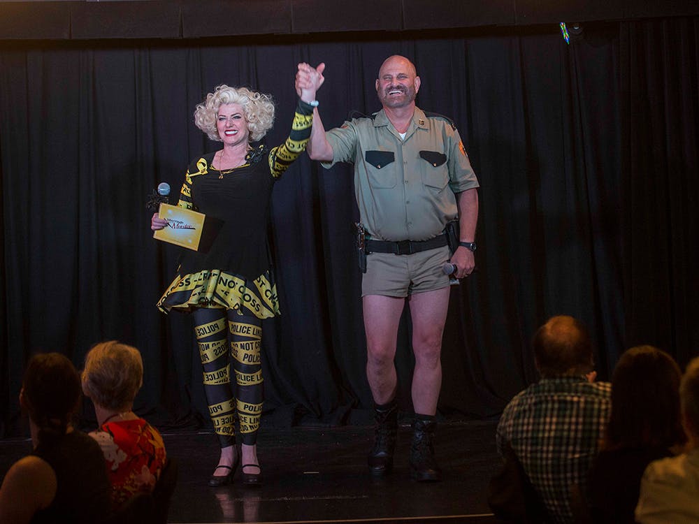 Marriage Can Be Murder performers taking a bow on stage at The Venue at Masquerade Village inside Rio All-Suite Hotel Las Vegas, with audience members enjoying the comedy murder mystery dinner show