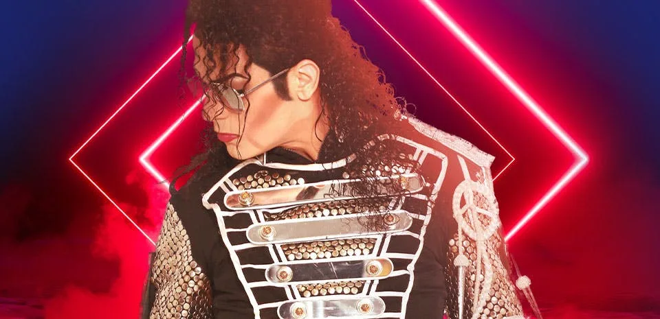 MJ Live — Michael Jackson tribute performer in a studded silver-and-black military jacket against red neon at Saxe Theater, Planet Hollywood Las Vegas