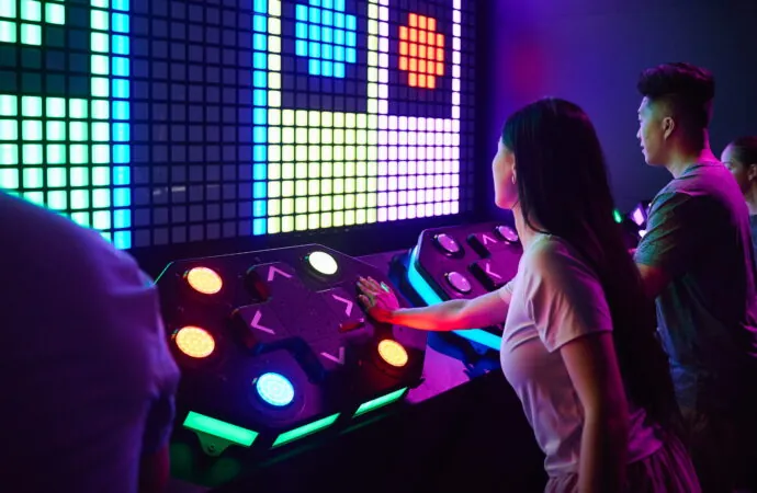 A player uses a light-up console during Activate's Mega Grid game