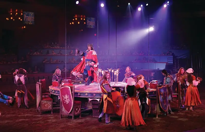 Tournament of Kings — king presiding over the medieval feast as performers gather around the arena
