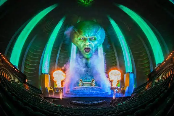 Inside MSG Sphere Las Vegas — the Wizard's enormous green face projected across the full dome with fire effects and fog